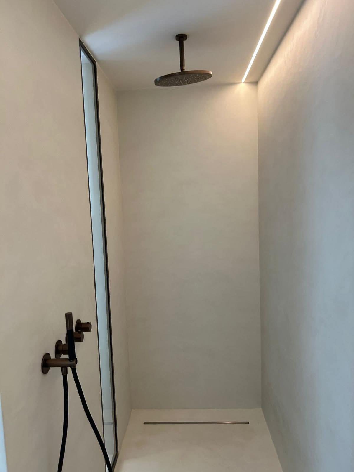 Walk-in microcement shower with seamless walls