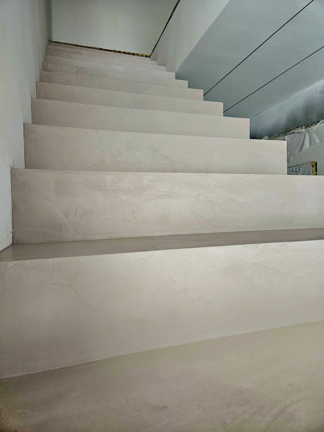 Seamless microcement staircase with anti-slip nosings